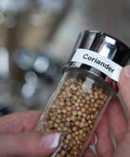 Rock Solid Compact Handheld Label Printer Featuring Bold Fonts And Live Graphical Display For Nailing Home Office Paperwork And Quick Storage Organization Hustle used to label a glass spice jar with coriander.