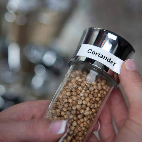 Rock Solid Compact Handheld Label Printer Featuring Bold Fonts And Live Graphical Display For Nailing Home Office Paperwork And Quick Storage Organization Hustle used to label a glass spice jar with coriander.