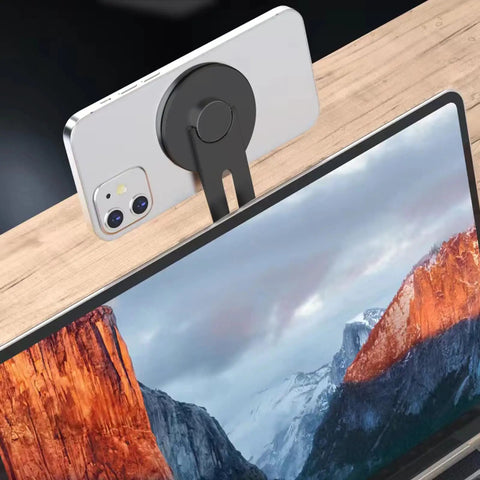 Ultra Thin Aluminum Laptop Phone Holder With Magnetic Quick Mount on laptop edge, holding smartphone, silver color.