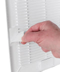 Hand applying adhesive to No Sweat Easy Patch Wall Repair Access Panel, a 10-inch self-stick drywall cover.