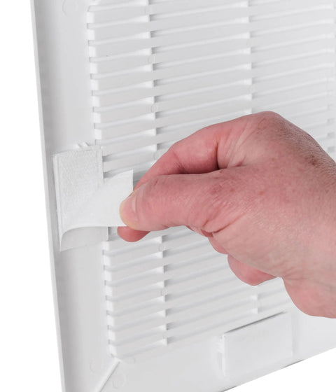 Hand applying adhesive to No Sweat Easy Patch Wall Repair Access Panel, a 10-inch self-stick drywall cover.