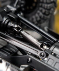 Close-up of beefed up hardened steel drive shaft with D shaped holes for 1/24 scale RC crawlers upgrades on chassis.