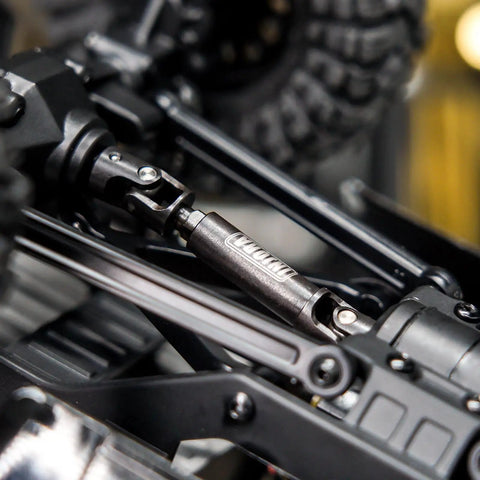 Close-up of beefed up hardened steel drive shaft with D shaped holes for 1/24 scale RC crawlers upgrades on chassis.