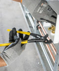 12 Inch Quick Adjust Pump Pliers With Tongue And Groove Klaw Push Button Ratchet For Fast Adjustments Narrow Profile For Working In Tight Spaces Heavy Duty Water Pump Pliers For Home DIY And Pros being used by a gloved hand on metal pipes