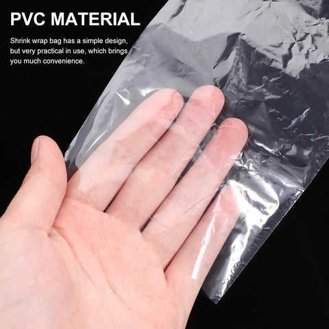100Pcs PVC Heat Shrink Wrap Bags For Bottles And Medicine Easy To Use Sealing Film That Keeps Products Fresher Clear Plastic Shrink Wrap For Packaging And Shipping Great For Bulk Bottling DIY Craft And Makeup Storage, clear PVC shrink bag held in hand