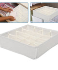 Super Slick 16 Compartment Foldable Drawer Storage Box For Underwear And Socks Made From Soft Cotton Linen Blend In Warm Beige on a wooden surface.