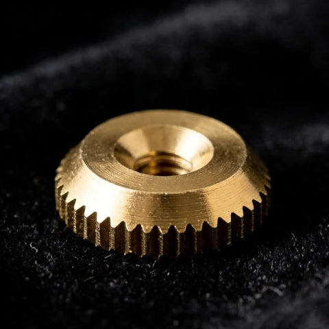 Close-up of a brass nut from the 12 Piece Brass Clock Hand Nut Set For Replacement Hardware 5mm 6mm 10mm OD Threaded Fasteners