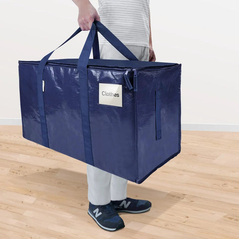 Person carrying Six Pack Extra Large Moving Bags Heavy Duty With Zippers And Carrying Handles Tough As Nails Waterproof Storage Bags For Moving Camping And Closet Organization Navy 27 By 14 By 15 Inches Up To 24 Gallons And 100 Lbs