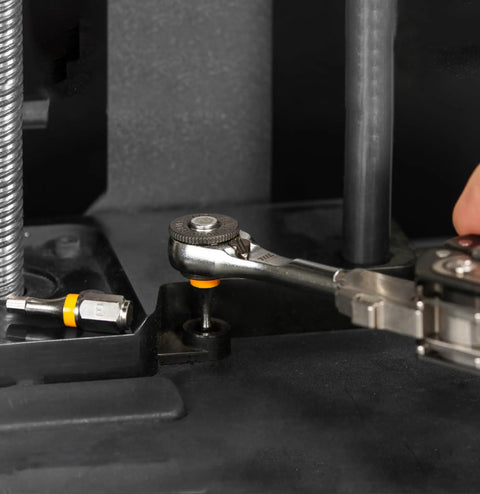 Close-up of Go To One Quarter Inch Hex End EDC Ratchet Wrench For Multitools with hex bit adapters in use on machinery