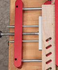 Precision Woodworking Mortise And Tenon Jig With Self Centering Loose Tenon Doweling Kit, showing red clamps and wood alignment.
