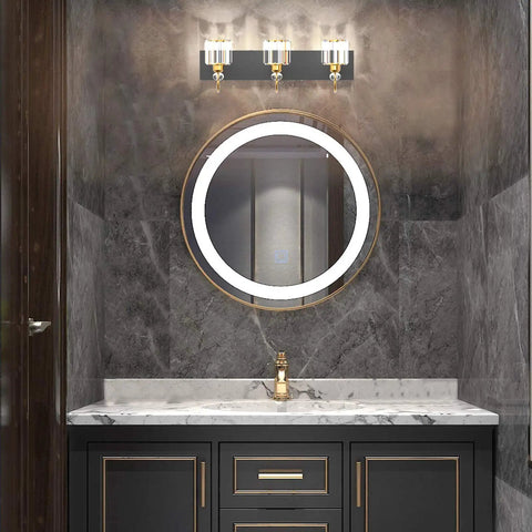 Three Light Black Metal And Crystal Vanity Light Fixture for Modern Bathrooms above round mirror on marble wall