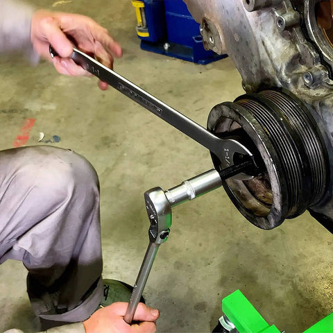 Mechanic using Long Reach Harmonic Balancer And Pulley Installer Kit with extra long forcing fasteners on engine pulley