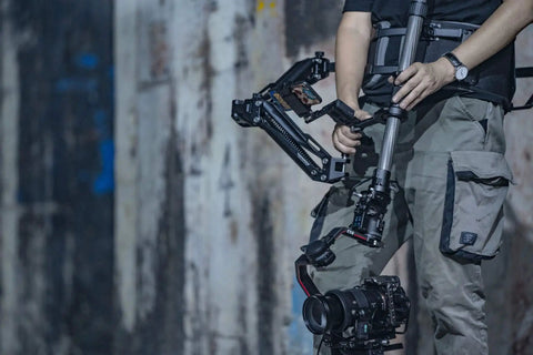 Operator using Float Handheld Gimbal Support System With V Mount For DJI RS3 Pro And RS2, showcasing pro level stability on set.