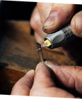 Close-up of hand using 30Pcs PCB Drill Bit Set for Jewelry Engraving and Circuit Boards, detailing tungsten micro drill bit on metal piece.