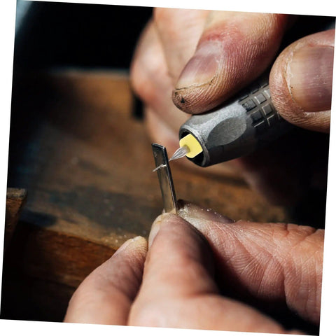 Close-up of hand using 30Pcs PCB Drill Bit Set for Jewelry Engraving and Circuit Boards, detailing tungsten micro drill bit on metal piece.