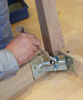 Person tightening a bolt with a wrench on a wooden structure using Three Pack M8 1.25 X 20mm Left Hand Hex Head Bolt Black Oxide Carbon Steel Reverse Thread Fastener Shop Grade Built Tough Heavy Duty Hardware For Automotive And Industrial Work.