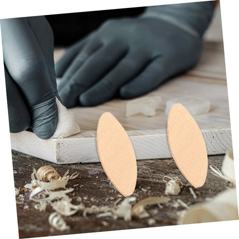100 Piece Hardwood Biscuit Joiner Set for Woodworkers Tongue and Groove Board Carving Tenon Tool Kit on a workbench.