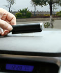 Rock Solid Transponder Mounting Strips For Windshield Toll Tags being applied to a dashboard for secure mounting.