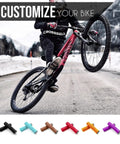 Cyclist performing a wheelie with Lock-On MTB Grips For Mountain Bike BMX And E-Bike, visible in various colors.