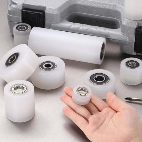4 Pack Nylon Roller Wheels With Bearings For CNC Guiding And Flat Belt Idler Pulleys shown with hand for size comparison