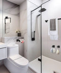 Matte Black 5 Piece Bathroom Hardware Set With Wall Mounted Towel Bar Towel Holder And Towel Racks Kit SUS304 Stainless Steel Rustproof Fixtures For Ultra Durable Bath Organization 23.6 Inch installed in a modern bathroom