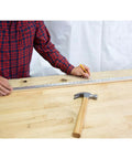 Person using a 36 Inch Aluminum Yard Stick With Precision Straight Edge Clear Thermo Bonded Graduations In SAE And Metric on a table