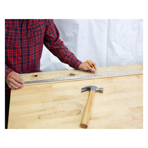 Person using a 36 Inch Aluminum Yard Stick With Precision Straight Edge Clear Thermo Bonded Graduations In SAE And Metric on a table