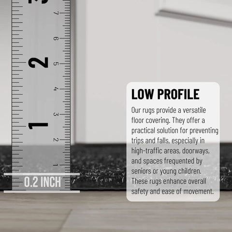 Close-up of low-profile non-slip rug with scrape rib pile, black color, measures 2 ft by 12 ft for indoor and outdoor use.