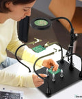 Pro Grade Soldering Station With 3X Magnifying Lamp And LED Light USB Powered Third Hand Tool used by a person for precise electronics work