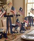 Six Pack 4x6 Inch Fabric Mini Flags On Sticks For 4th Of July Home Decor And Independence Day Parties Vintage Retro Patriotic Flags displayed on a dining table with vintage decor.