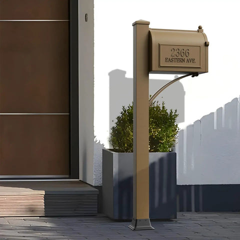 Bronze mailbox on post labeled '2366 Eastern Ave' in front of modern house entrance with potted plant.