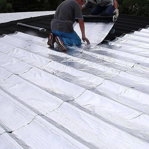 Two people applying Beefy Leak Stopper Self Adhesive Roofing Tape For Shed Repairs on a roof for leak sealing.