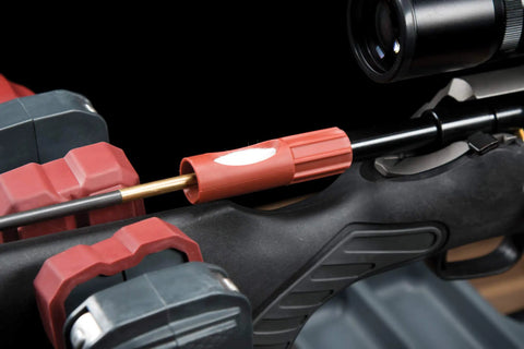 Universal Bore Guide With Three Muzzle Guides for cleaning rod alignment on rifle barrel, showing red plastic guide clamp