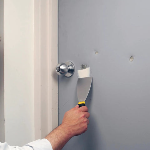 Heavy Duty Ready Patch Spackle Gallon For Interior And Exterior Repairs Sticks To Metal Dries Fast And Cures Rock Hard Shrink Resistant And Wont Sag Like Drywall Mud Great For Dents In Metal Doors And Siding Paintable When Dry being applied to a metal door dent with a putty knife