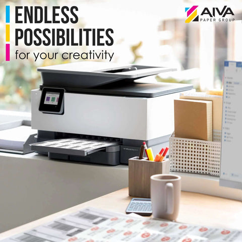 Front view of white office printer on a desk with paper; AIVA Paper Group logo top-right