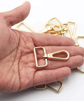 Hella Sturdy 15 Pack Solid Zinc Alloy D Ring Swivel Lobster Claw Clasp Hardware For Crafting Lanyards Bag Straps And Outdoor Gear Attachments Anti Rust Gold Finish Trigger Clip Snap Hook in hand.