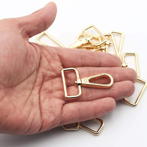 Hella Sturdy 15 Pack Solid Zinc Alloy D Ring Swivel Lobster Claw Clasp Hardware For Crafting Lanyards Bag Straps And Outdoor Gear Attachments Anti Rust Gold Finish Trigger Clip Snap Hook in hand.