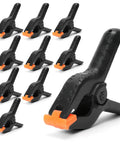 ECY 4.5-inch heavy-duty plastic spring clamps with orange jaws; ten clamps shown, foreground close-up