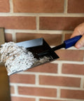 15 Inch Fireplace Ash Shovel With Wider Head For Quick Cleanup Heavy Duty Manganese Steel Scoop shown with ash