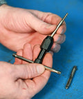 Hands holding T-Handle Tap Wrench For Quarter To Half Inch Taps Steel Construction Precise Control Easy Install And Firm Grip