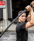 Person holding Realistic Practice Katana Sword For Martial Arts Training Real Deal Feel Dope Bokken Style, textured handle.