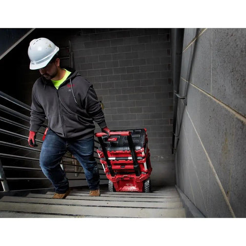 Person carrying Packout 22 Inch Tool Box With Heavy Duty Latches And Interior Organizer Trays Durable Modular Storage System on stairs