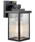 Set And Forget Dusk To Dawn Wall Mount Porch Light With Auto Photocell Sensor in matte black with glass shade for outdoor use.