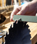 Dia Fold Handy Portable Pocket Diamond Sharpener Double Sided With Extra Fine And Fine Grits sharpening a saw blade in workshop.