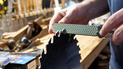 Dia Fold Handy Portable Pocket Diamond Sharpener Double Sided With Extra Fine And Fine Grits sharpening a saw blade in workshop.