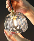 Close-up of clear glass shade with lit LED for Three Light Crystal Chandelier With Dimmable LED Lighting For Kitchen Island.