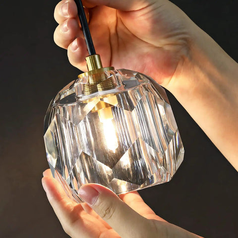 Close-up of clear glass shade with lit LED for Three Light Crystal Chandelier With Dimmable LED Lighting For Kitchen Island.