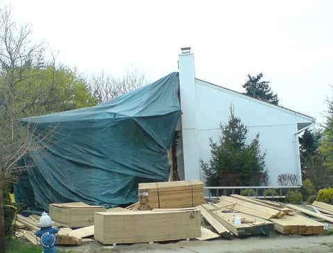 Heavy-Duty 12x14 Foot Poly Tarp With Reversible 8-Mil Waterproof Coverage sheltering construction materials on site