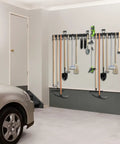 Heavy Duty Metal Garage Tool Organizer Wall Mount Kit Four Pack With Extension Cord Straps holding tools on wall