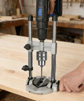 Hands using Drill Guide Stand For Cordless Drills And More Portable Drill Press Attachment with Half Inch Chuck on wooden surface